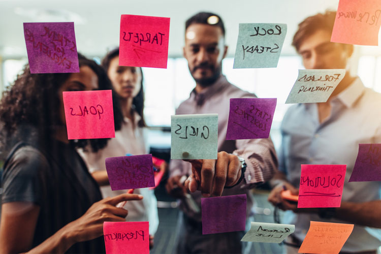 Group of people collaborating with sticky notes